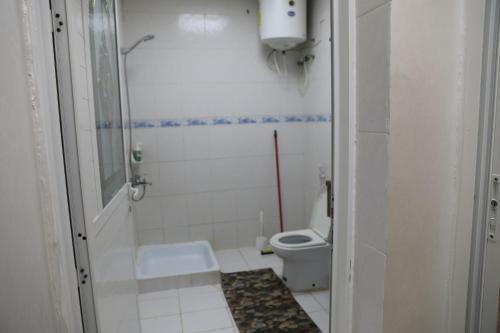 a small bathroom with a toilet and a shower at Aljood Resort in Ras al Khaimah