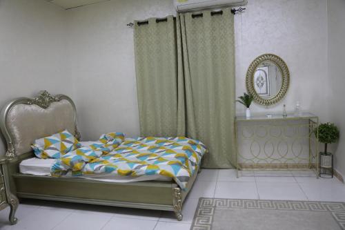 a bedroom with a bed and a mirror at Aljood Resort in Ras al Khaimah