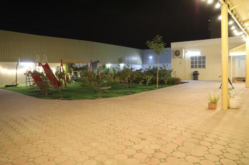 an empty courtyard at night with a building at Aljood Resort in Ras al Khaimah
