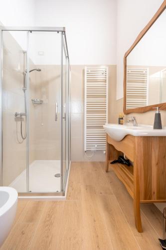 a bathroom with a glass shower stall and a sink at Agriturismo Ai Dossi in Verona