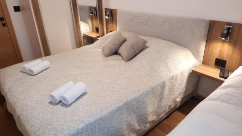 a bedroom with a bed with two towels on it at Apartman K&N - Jahorinska Vila in Jahorina