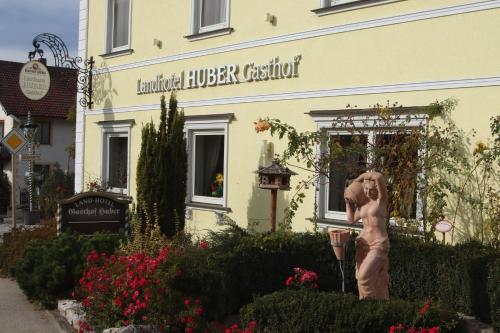 a statue of a woman in front of a building at Landhotel Gasthof Huber in Merching