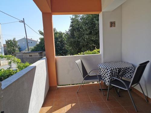 a patio with a table and chairs on a balcony at Apartments Mira in Bibinje