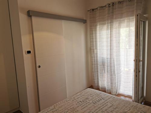 a bedroom with a closet and a bed in front of a window at Apartments Mira in Bibinje