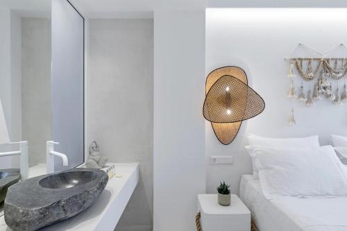 a bathroom with a large sink and a bed at Boho Sapiens Marina - Seagnature, Adamas Port in Adamantas