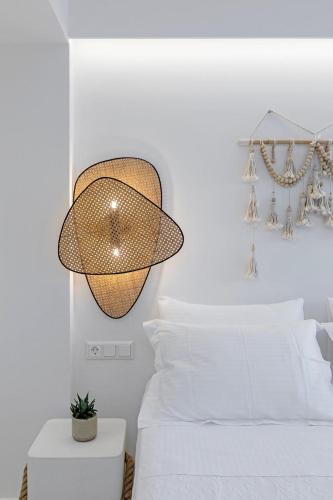 a bedroom with a bed and a chandelier at Boho Sapiens Seagnature in Adamantas