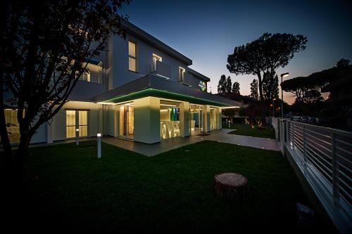 a house with its lights on in the yard at Love Boat Hotel - The Original in Riccione