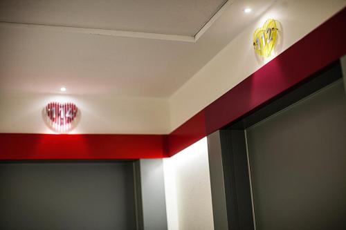 a room with a red stripe on the ceiling at Love Boat Hotel - The Original in Riccione