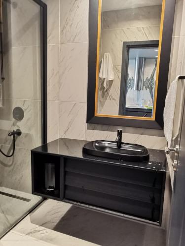 a bathroom with a black sink and a mirror at BENESTA BEYOGLU in Istanbul