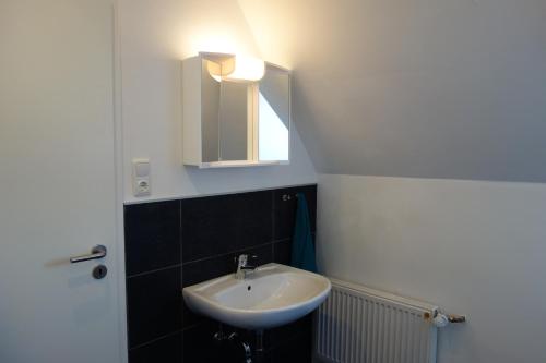 a bathroom with a sink and a mirror at Ferienwohnungen Viersen in Viersen
