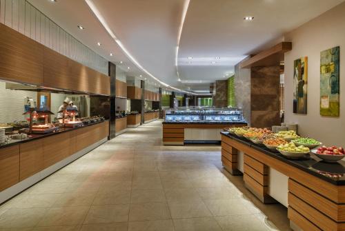 a buffet line in a restaurant with fruits on display at Aska Lara Resort & Spa Hotel in Lara
