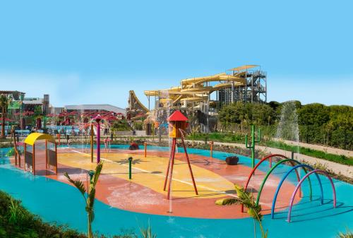 a water park with a roller coaster in the background at Aska Lara Resort & Spa Hotel in Lara