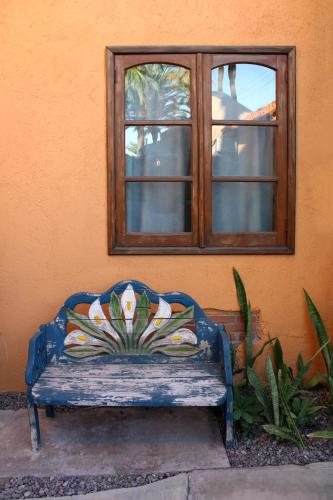 a blue bench sitting in front of a window at Sukasa Bungalows in Loreto