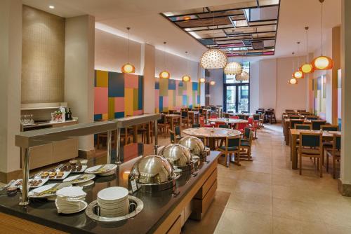 a restaurant with tables and chairs and a buffet at Aska Lara Resort & Spa Hotel in Lara