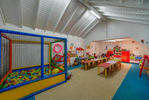 a classroom with tables and chairs and a play room at Aska Lara Resort & Spa Hotel in Lara