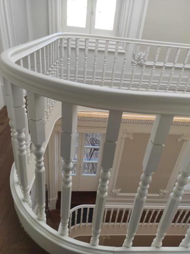 a white spiral staircase in a room at Flag Design Hotel in Viana do Castelo