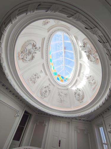 a domed ceiling with a stained glass window on it at Flag Design Hotel in Viana do Castelo