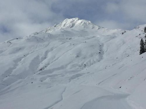 a mountain covered in snow on a cloudy day at Residenz am Berg in Jochberg