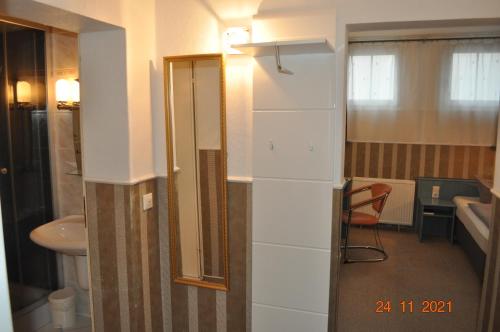 a bathroom with a toilet and a sink at Parkhotel Schwedt in Schwedt