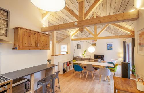 une cuisine et un salon avec une table et des chaises dans l'établissement La Maisonnette-Aix, à Aix-les-Bains