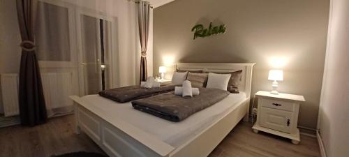 a bedroom with a large bed and a window at Angel Residence in Sibiu