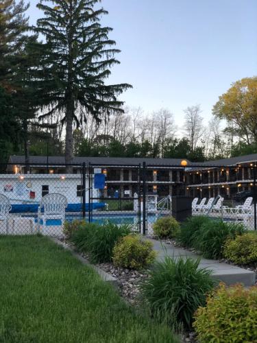 a playground with white chairs and a pool at Amber's Inn and Suites in Wisconsin Dells