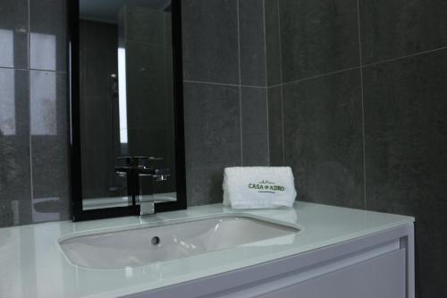 y baño con lavabo blanco y espejo. en CASA DO ADRO -GRANEL, en Nordeste