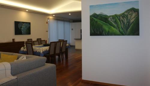 a living room with a couch and a table at CASA DO ADRO -GRANEL in Nordeste