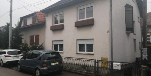 a gray car parked in front of a house at Apartman Goldy in Zagreb