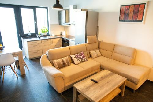 a living room with a couch and a table at BIO Residence Apartments Timisoara in Dumbrăviţa