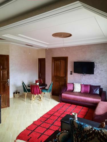a living room with a couch and a table at DARY in Fès