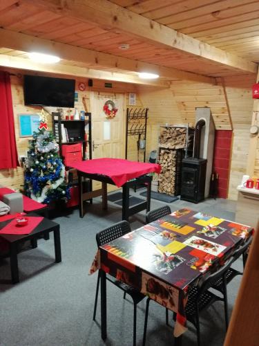a room with a table and a christmas tree at Brvnara Orfej in Gornje Pale