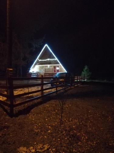 a barn with a light on the roof at night at Brvnara Orfej in Gornje Pale