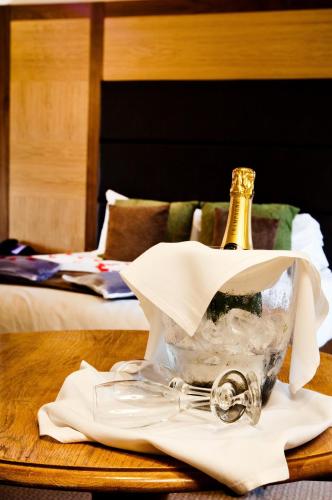 a bottle of champagne sitting on top of a table at Abbey Hotel Golf & Spa in Redditch