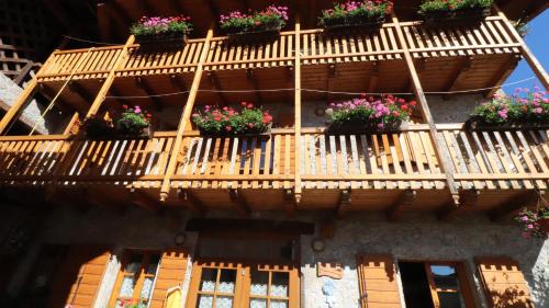 a wooden staircase with potted plants on a building at Dependance GRIMANI in Ampezzo