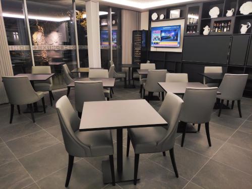 a restaurant dining room with tables and chairs at Flag Design Hotel in Viana do Castelo