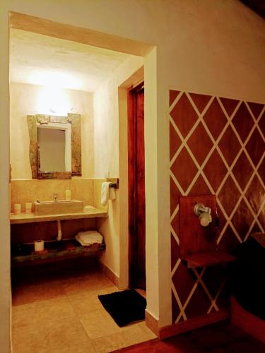 a bathroom with a sink and a mirror at Cabañas La Ruka in Los Reartes