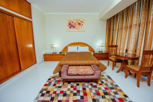 a bedroom with a bed and a table and a chair at Grima Hotel in Huánuco