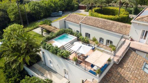 an aerial view of a house with a swimming pool at Donna Carmela Resort & Lodges in Riposto