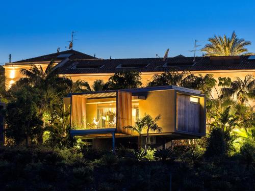a house with a balcony in front of a building at Donna Carmela Resort & Lodges in Riposto