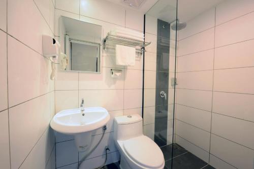 a bathroom with a toilet and a sink and a shower at Season Inn Langkawi Motel in Kuah