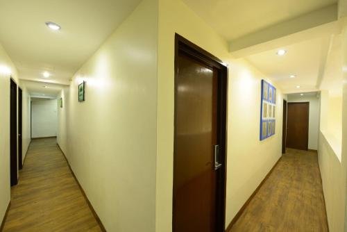 a hallway with a door and a wooden floor at Season Inn Langkawi Motel in Kuah