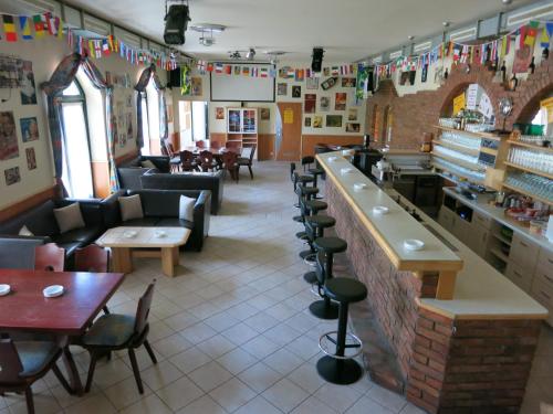 a restaurant with a bar and tables and chairs at Pension Lang in St. Andrä am Zicksee