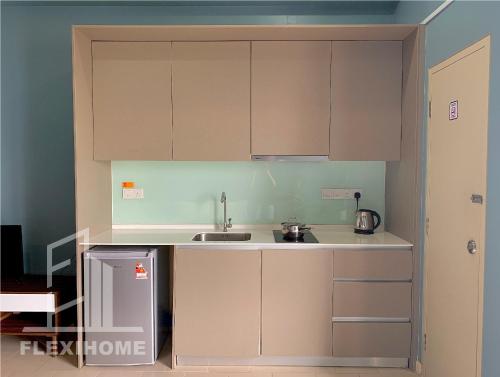a kitchen with white cabinets and a sink at 9am-5pm, SAME DAY CHECK IN AND CHECK OUT, Work from Home, Comfy & Quiet Tamarind Suites-Cyberjaya by Flexihome-MY, in Cyberjaya