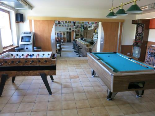 two pool tables sitting in a room with at Pension Lang in St. Andrä am Zicksee