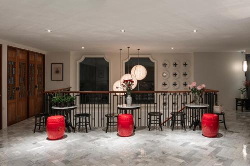 a room with tables and chairs and a balcony at The Lantern Hatyai Hotel in Hat Yai