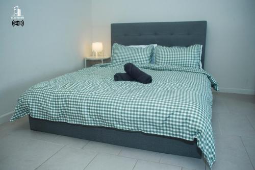 a bed with a black pillow on top of it at 9am-5pm, SAME DAY CHECK IN AND CHECK OUT, Work from Home, Comfy & Quiet Tamarind Suites-Cyberjaya by Flexihome-MY, in Cyberjaya