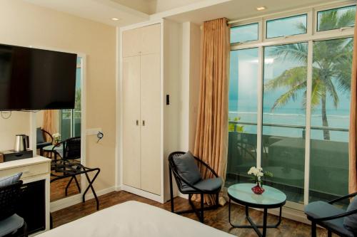 a hotel room with a view of the ocean at Acacia Beach Hotel in Hulhumale