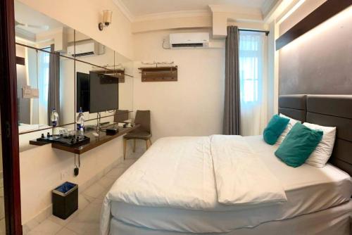 a bedroom with a bed and a sink in a room at Dhimyaath Stay in Male City