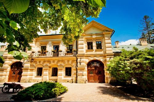 a large yellow building with a balcony on it at Zamek w Krasiczynie in Krasiczyn